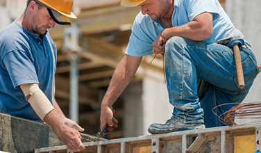 What types of injuries can result from not wearing safety boots on a construction site?
